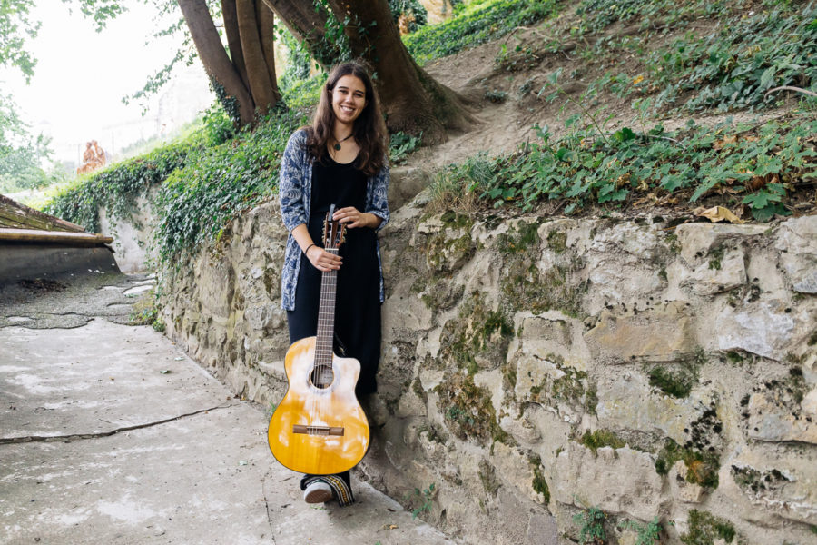 Veronika pri kamennom múriku s gitarou v ruke